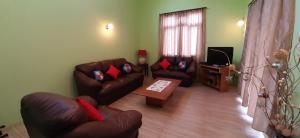 a living room with two couches and a coffee table at Casa Accacias in Port Louis