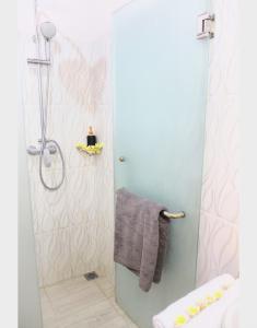 a bathroom with a shower with a gray towel at Kandjeng Puri Kailas Canggu in Sempidi +36 photos