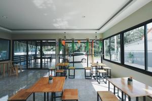 a restaurant with tables and chairs and a car outside at HillSide Boutique in Suratthani