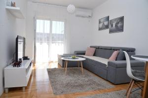 a living room with a couch and a table at Apartment ''Dream&Relax'' Trebinje in Trebinje