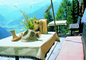 a table with a hat on top of a mountain at Arcadia Appartments in Bad Hofgastein