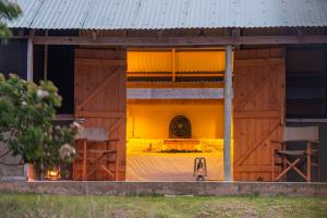 a room with a bed inside of a barn at Gugulesizwe Camp in Mabibi