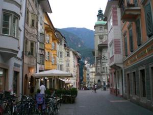 a city street with buildings and bikes parked on the street at Apartment Bolzano in Bolzano