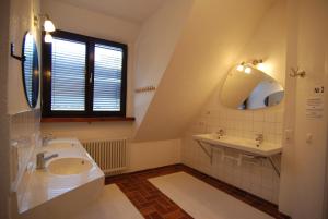 a bathroom with a tub, sink, mirror and toilet at Spa-Hostel in Freiburg im Breisgau