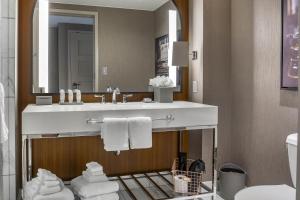a bathroom with a sink and a mirror at Omni Louisville Hotel in Louisville