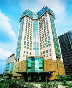 a large building with many windows in a city at Menara Peninsula Hotel in Jakarta