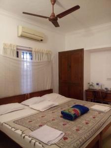 a bedroom with a bed with a ceiling fan at Nathans Holiday Home in Cochin
