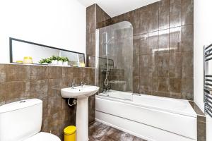 a bathroom with a sink and a tub and a toilet at City Suites in Chester