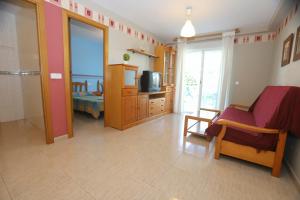 a living room with a room with a television and a room with at COSTA DAURADA APARTAMENTS - Larimar in Salou
