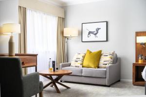 a living room with a couch and a table at voco Oxford Spires by IHG in Oxford