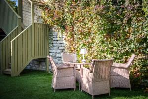 a patio with a table and chairs on the grass at City Center Garden Camping in Tallinn