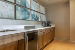 a kitchen with a sink and a counter top at Omni Louisville Hotel in Louisville