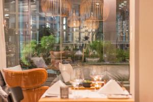 a restaurant with a table and chairs and a window at Forum - das Business & Lifestylehotel in Widnau