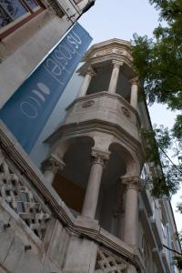 a building with columns and a sign on it at WW Hostel & Suites in Coimbra