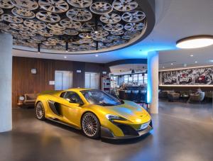 
a car that is sitting in a room at V8 HOTEL Motorworld Region Stuttgart in Böblingen
