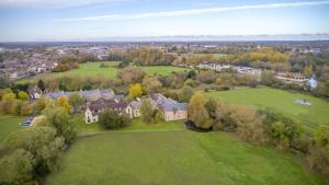 an aerial view of a large house in a field at voco Oxford Spires, an IHG Hotel in Oxford