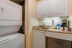 a kitchen with a sink and a refrigerator at Villas Of Amelia Island in Amelia Island