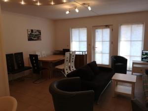 a living room with a couch and a table and chairs at Ferienhaus Seedo in Herleshausen