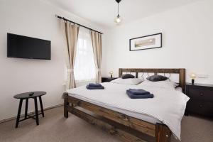 a bedroom with a bed with two blue towels on it at Restaurace Hotel Praha in Nižbor