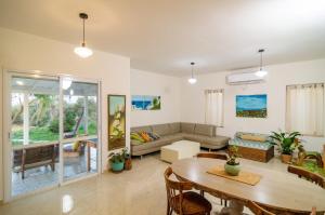 a living room with a table and a couch at Home for Air -- 9 minutes from sea of Galilee in Giv'at Yo'av