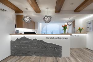 a kitchen with a counter with a picture of a mountain at Hotel Vorab - Kulinarische Vielfalt in Flims