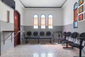 a waiting room with chairs and stained glass windows at Hotel Park Leste, São Paulo in Sao Paulo