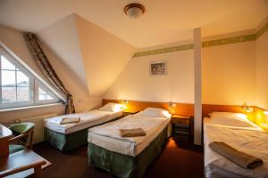 a hotel room with two beds and a window at Hotel Margo in Cedynia