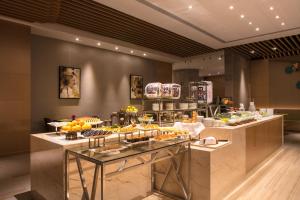 una linea a buffet con molti tipi di cibo diversi di Holiday Inn Hangzhou Gongshu, an IHG Hotel a Hangzhou