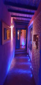 a hallway of a house with a blue light at Villamereu in Pula