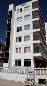 a white building with a staircase in front of it at Hotel Royal in Alanya