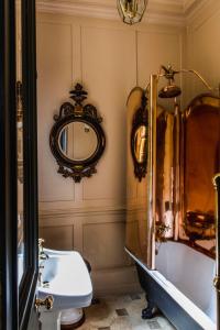 
a bathroom with a toilet, sink and mirror at Hazlitt's in London
