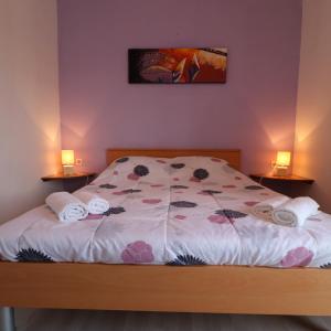 a bedroom with a bed with two lamps on it at Seaside Apartment Franica in Vela Luka