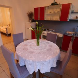 a kitchen with a table with a vase on it at Seaside Apartment Franica in Vela Luka