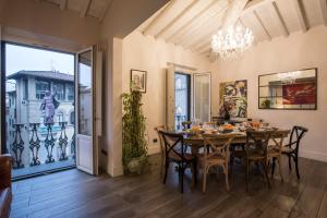 a dining room with a table and chairs and a chandelier at Tornabuoni View in Florence