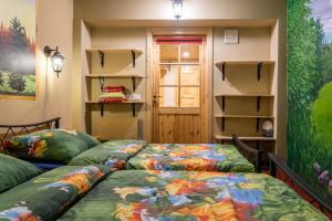 two beds in a room with open shelves at City Center Garden Camping in Tallinn