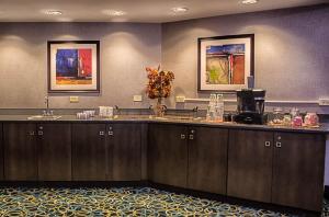 a reception counter in a hotel room with paintings on the wall at Holiday Inn Niagara Falls-Scenic Downtown, an IHG Hotel in Niagara Falls