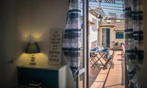 a door to a patio with a table and a lamp at Scricciolo in Viareggio