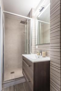 a bathroom with a sink and a shower at Scricciolo in Viareggio +14 photos