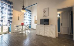 a living room with a television and a table at Scricciolo in Viareggio