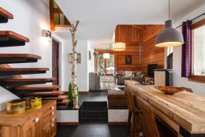 a kitchen with a wooden counter and a living room at Warm & Cosy 3BR Chalet w/ Fireplace in Nature in Les Houches