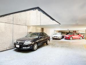 a group of cars parked in a garage at Hotel Antas in Mexico City
