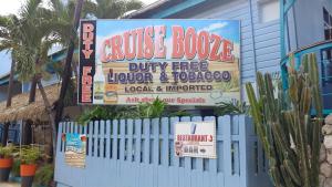 a sign for a house booze buy free liquor and tobacco at SandCastles Holiday #C9 in Ocho Rios