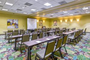 a conference room with tables and chairs and a whiteboard at Holiday Inn Indianapolis North-Carmel by IHG in Carmel +34 photos