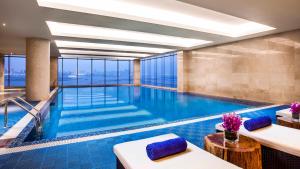a swimming pool in a hotel with a view at Holiday Inn Nanchang Riverside by IHG in Nanchang