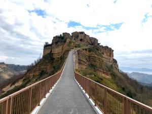 a bridge over a mountain with a castle on it at La Sorpresa Di Civita in Bagnoregio