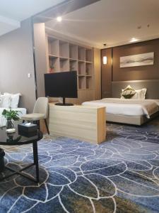 Postel nebo postele na pokoji v ubytování Guangzhou Homies Hotel