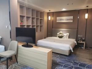 Postel nebo postele na pokoji v ubytování Guangzhou Homies Hotel