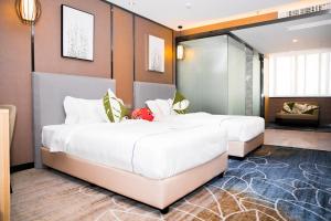 Postel nebo postele na pokoji v ubytování Guangzhou Homies Hotel