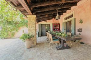 a porch with a wooden table with fruit on it at The Seacret Beachfront Villa in Nea Peramos