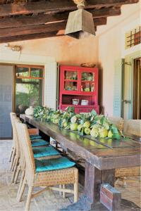 a large wooden table with a bunch of fruit on it at The Seacret Beachfront Villa in Néa Péramos +36 photos